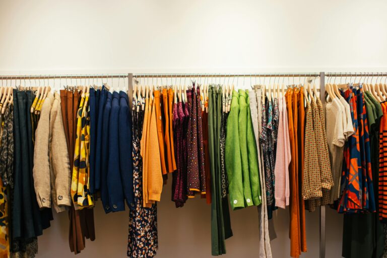 A vibrant display of assorted garments on a rack in a fashion store.